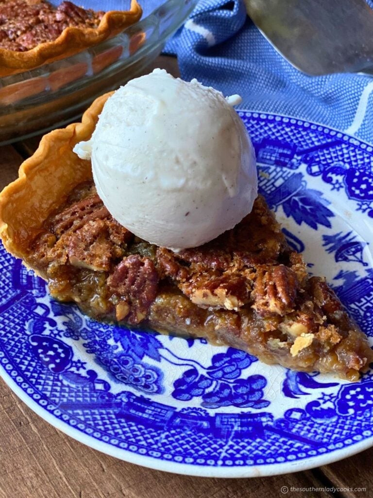 Maple Pecan Pie slice on a plate with ice cream