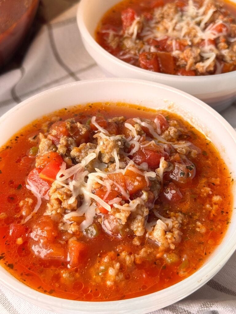 Bowl of Italian Sausage Tomato Soup with mozzarella cheese